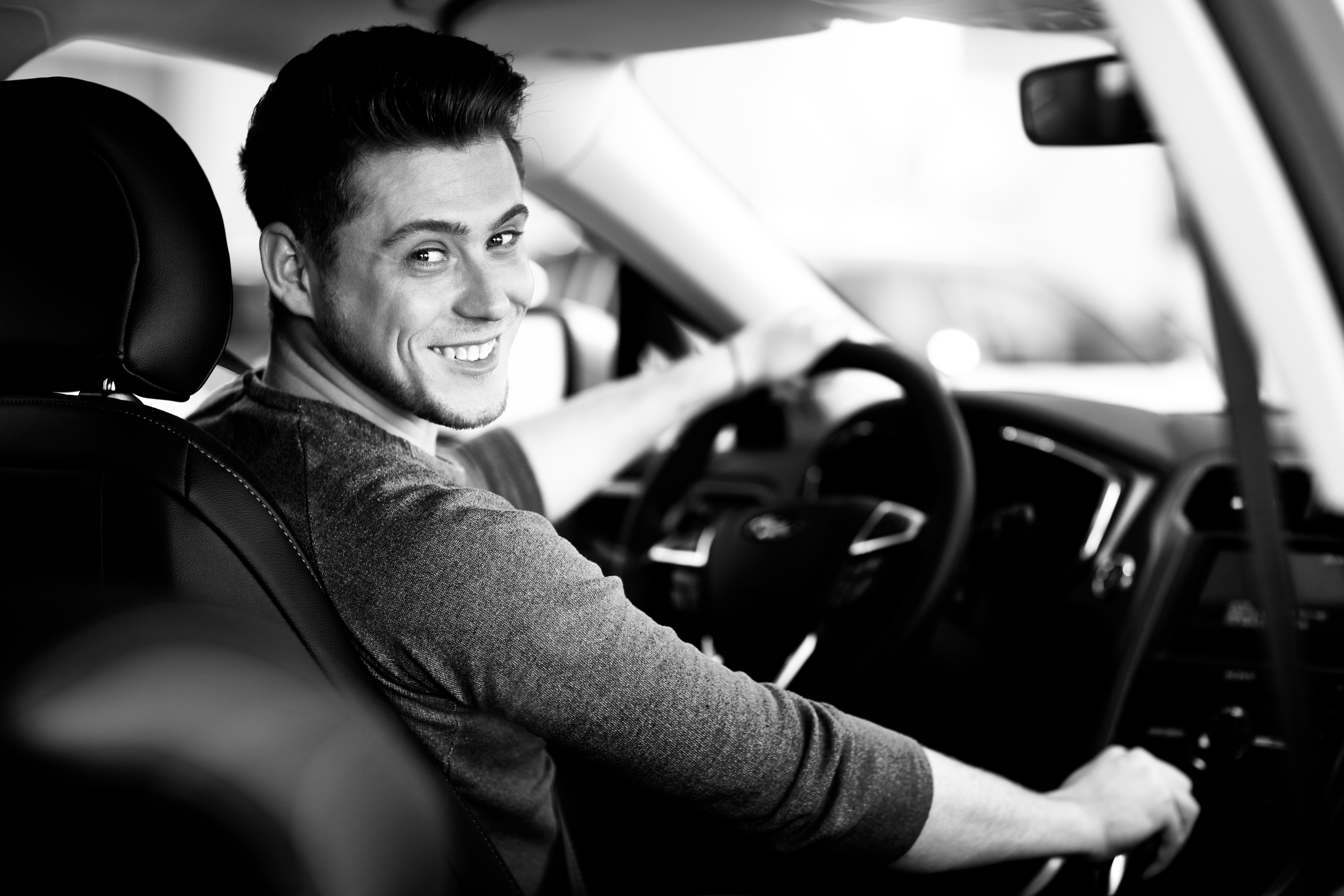 happy-young-male-driver-wheel